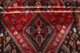Corner detail of 2000s Shiraz rug showing border pattern and Wool pile
