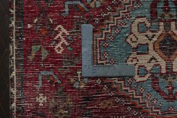 Backside of handmade 1970s Shiraz rug showing knot structure and weave density