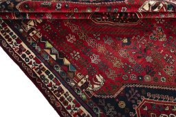 Corner detail of 2000s Shiraz rug showing border pattern and Wool pile