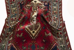 Corner detail of 2000s Shiraz rug showing border pattern and Wool pile