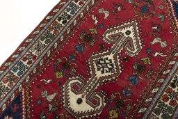 Backside of handmade 2000s Shiraz rug showing knot structure and weave density