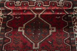 Corner detail of 2000s Shiraz rug showing border pattern and Wool pile