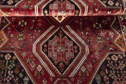 Corner detail of 2000s Shiraz rug showing border pattern and Wool pile