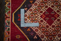 Backside of handmade 2000s Shiraz rug showing knot structure and weave density