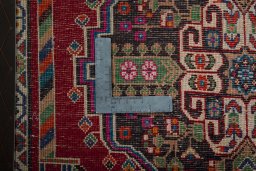 Backside of handmade 2000s Shiraz rug showing knot structure and weave density