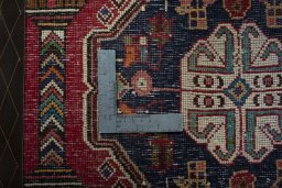 Backside of handmade 2000s Shiraz rug showing knot structure and weave density