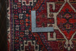 Backside of handmade 2000s Shiraz rug showing knot structure and weave density