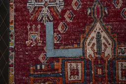 Backside of handmade 2000s Shiraz rug showing knot structure and weave density