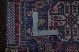 Backside of handmade 2000s Shiraz rug showing knot structure and weave density