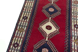 Backside of handmade 2000s Shiraz rug showing knot structure and weave density