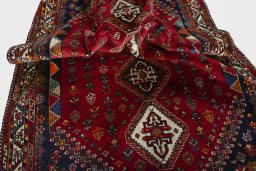 Corner detail of 2000s Shiraz rug showing border pattern and Wool pile