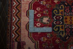 Backside of handmade 2000s Shiraz rug showing knot structure and weave density