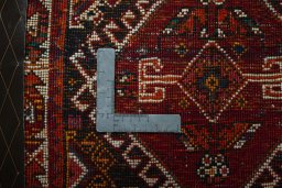 Backside of handmade 2000s Shiraz rug showing knot structure and weave density