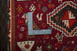 Backside of handmade 2000s Shiraz rug showing knot structure and weave density