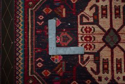 Backside of handmade 2000s Shiraz rug showing knot structure and weave density