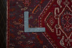 Backside of handmade 2000s Shiraz rug showing knot structure and weave density