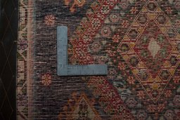 Backside of handmade 2000s Shiraz rug showing knot structure and weave density