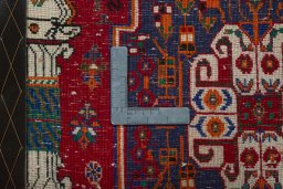 Backside of handmade 2000s Shiraz rug showing knot structure and weave density