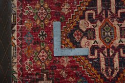 Backside of handmade 2000s Shiraz rug showing knot structure and weave density