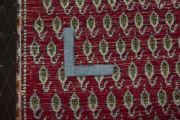Backside of handmade 2000s Shiraz rug showing knot structure and weave density