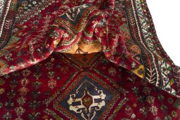 Corner detail of 2000s Shiraz rug showing border pattern and Wool pile