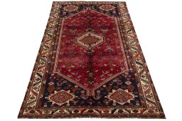 Surface texture of 2000s Shiraz rug with natural Wool and intricate pattern
