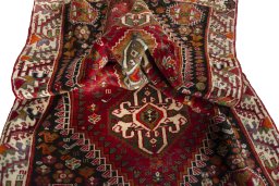 Corner detail of 2000s Shiraz rug showing border pattern and Wool pile