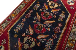 Backside of handmade 2000s Shiraz rug showing knot structure and weave density