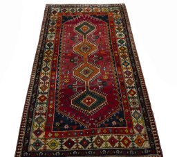 Surface texture of 2000s Shiraz rug with natural Wool and intricate pattern