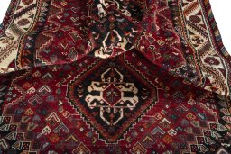 Corner detail of 2000s Shiraz rug showing border pattern and Wool pile