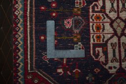 Backside of handmade 2000s Shiraz rug showing knot structure and weave density