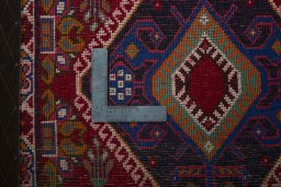 Backside of handmade 2000s Shiraz rug showing knot structure and weave density