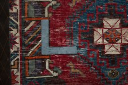 Backside of handmade 2000s Shiraz rug showing knot structure and weave density