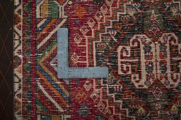 Backside of handmade 2000s Shiraz rug showing knot structure and weave density