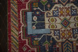 Backside of handmade 2000s Shiraz rug showing knot structure and weave density