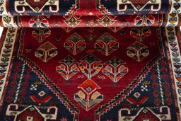 Corner detail of 2000s Shiraz rug showing border pattern and Wool pile