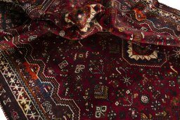 Corner detail of 2000s Shiraz rug showing border pattern and Wool pile