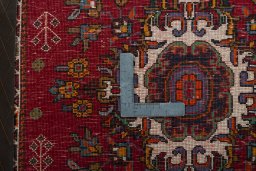 Backside of handmade 2000s Shiraz rug showing knot structure and weave density
