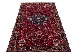 Surface texture of 2000s Shiraz rug with natural Wool and intricate pattern