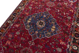 Backside of handmade 2000s Shiraz rug showing knot structure and weave density