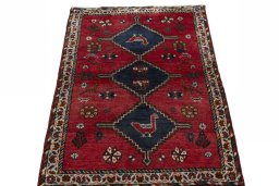 Surface texture of 2000s Shiraz rug with natural Wool and intricate pattern