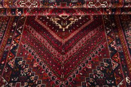 Corner detail of 2000s Shiraz rug showing border pattern and Wool pile