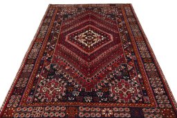 Surface texture of 2000s Shiraz rug with natural Wool and intricate pattern