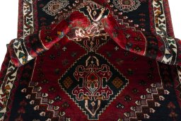 Corner detail of 2000s Shiraz rug showing border pattern and Wool pile