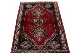 Surface texture of 2000s Shiraz rug with natural Wool and intricate pattern