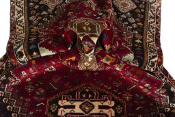 Corner detail of 2000s Shiraz rug showing border pattern and Wool pile