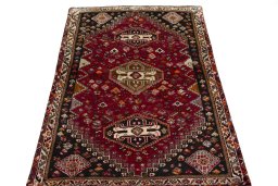 Surface texture of 2000s Shiraz rug with natural Wool and intricate pattern
