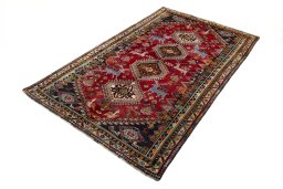 Corner detail of 2000s Shiraz rug showing border pattern and Wool pile