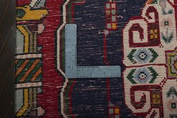 Backside of handmade 2000s Shiraz rug showing knot structure and weave density