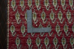 Backside of handmade 2000s Shiraz rug showing knot structure and weave density